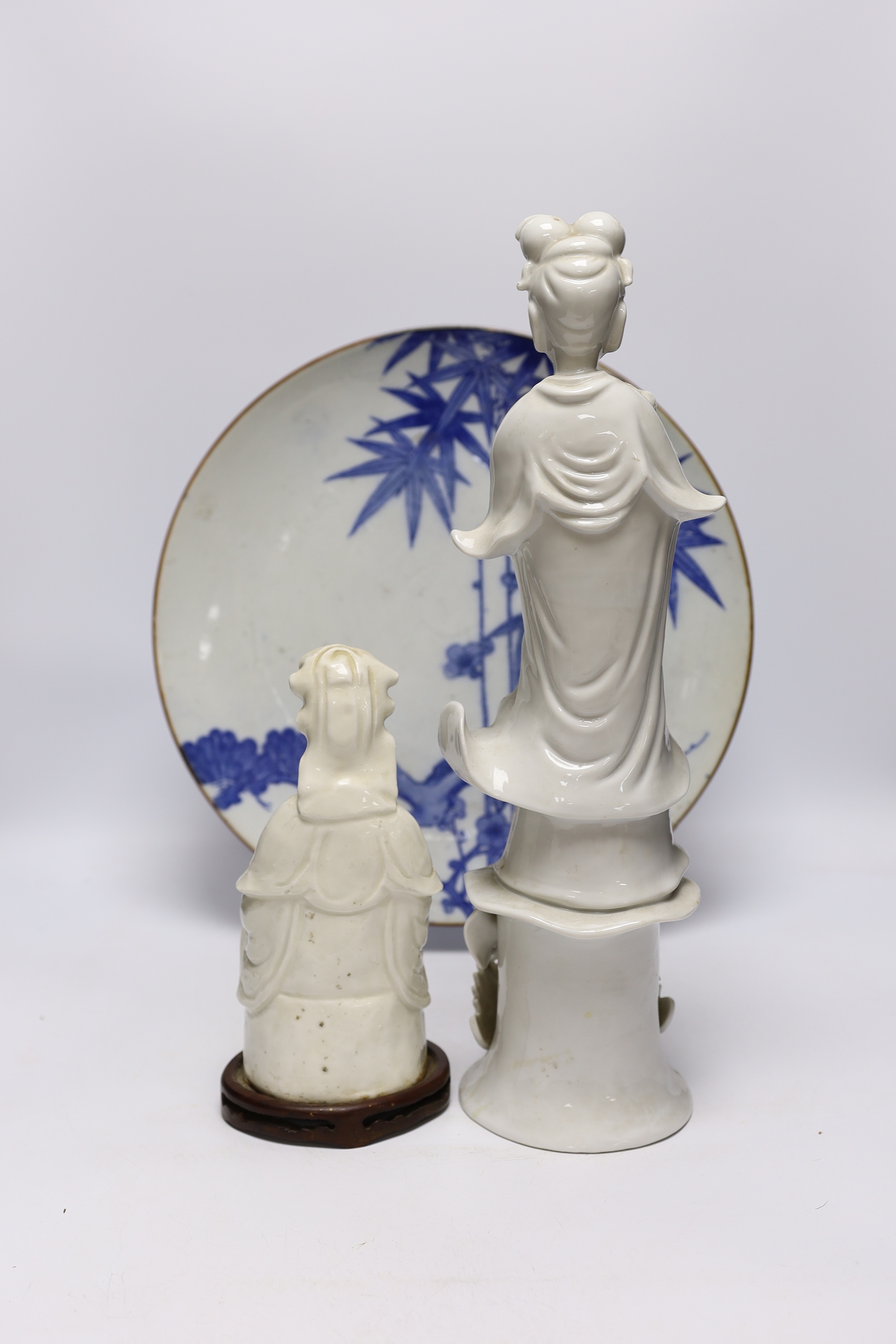 Japanese and Chinese ceramics including blue and white bamboo plate, blanc de chine figures, and Buddha with erotic scene to the base, largest 42cm high